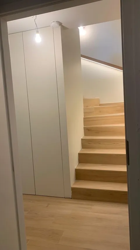 Light wooden staircase with built-in storage